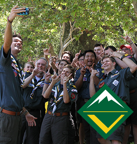 Venturers posing together for a group selfie outdoors, with the Venturing logo displayed in the foreground.