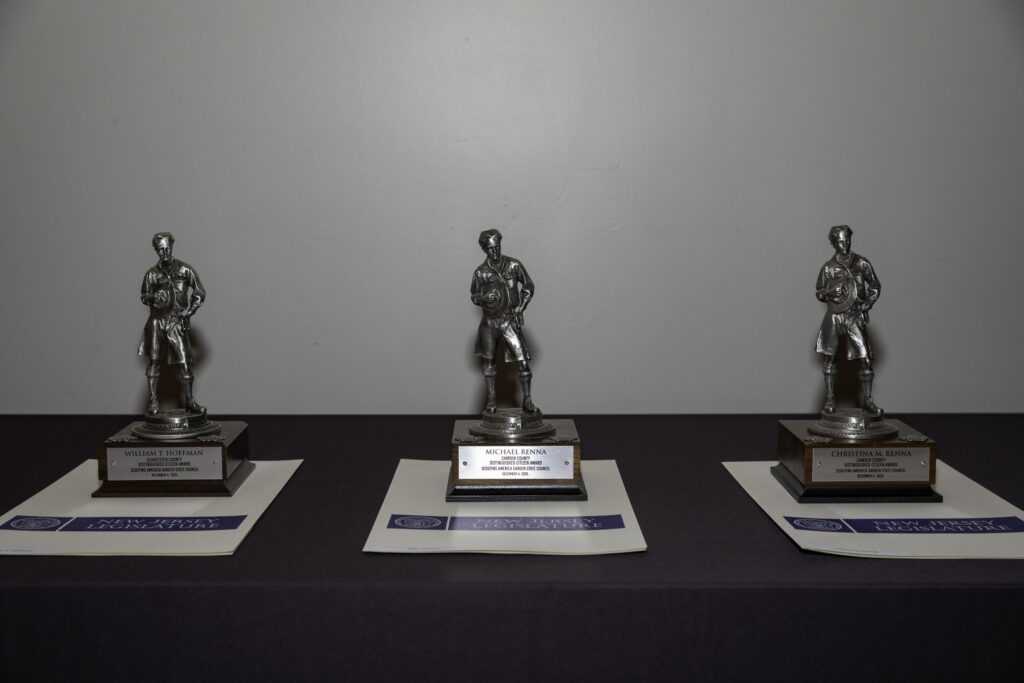 Three Distinguished Citizen Award statuettes displayed on a table for Garden State Council honorees.