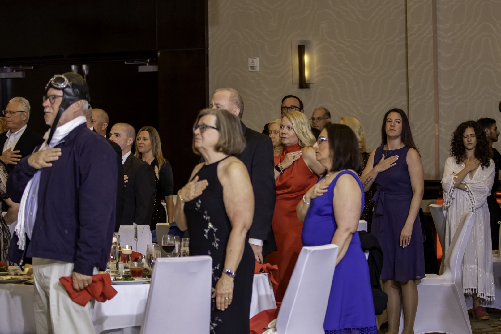 Guests standing with their hands over their hearts during a Garden State Council pledge ceremony.
