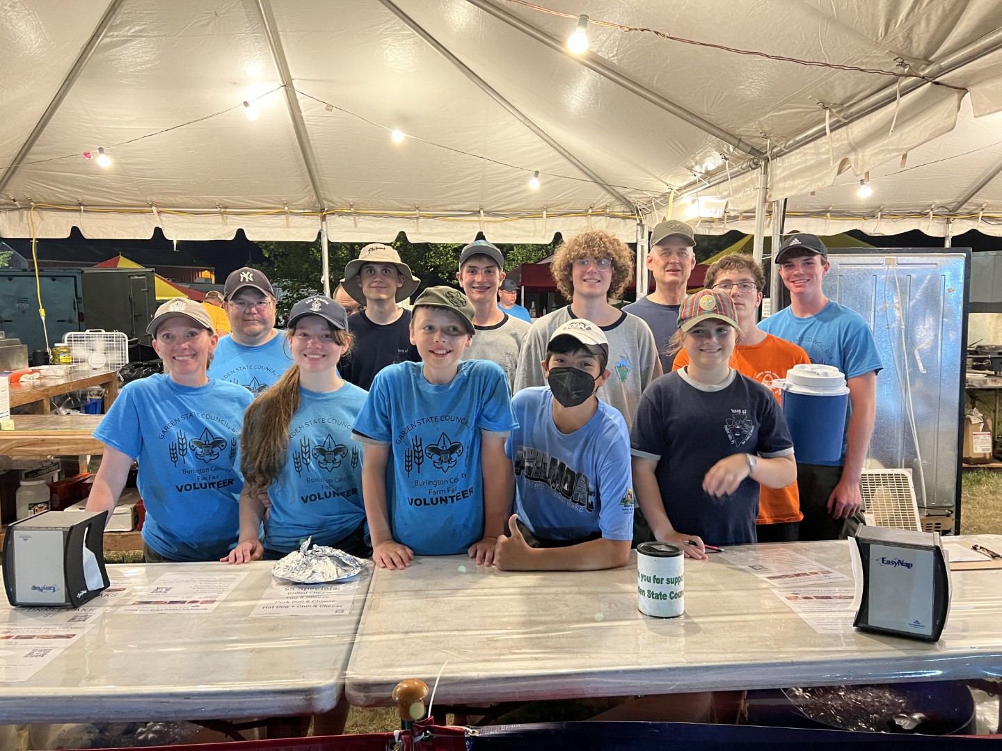 Group of Garden State Council Scouts and volunteers gathered behind a booth
