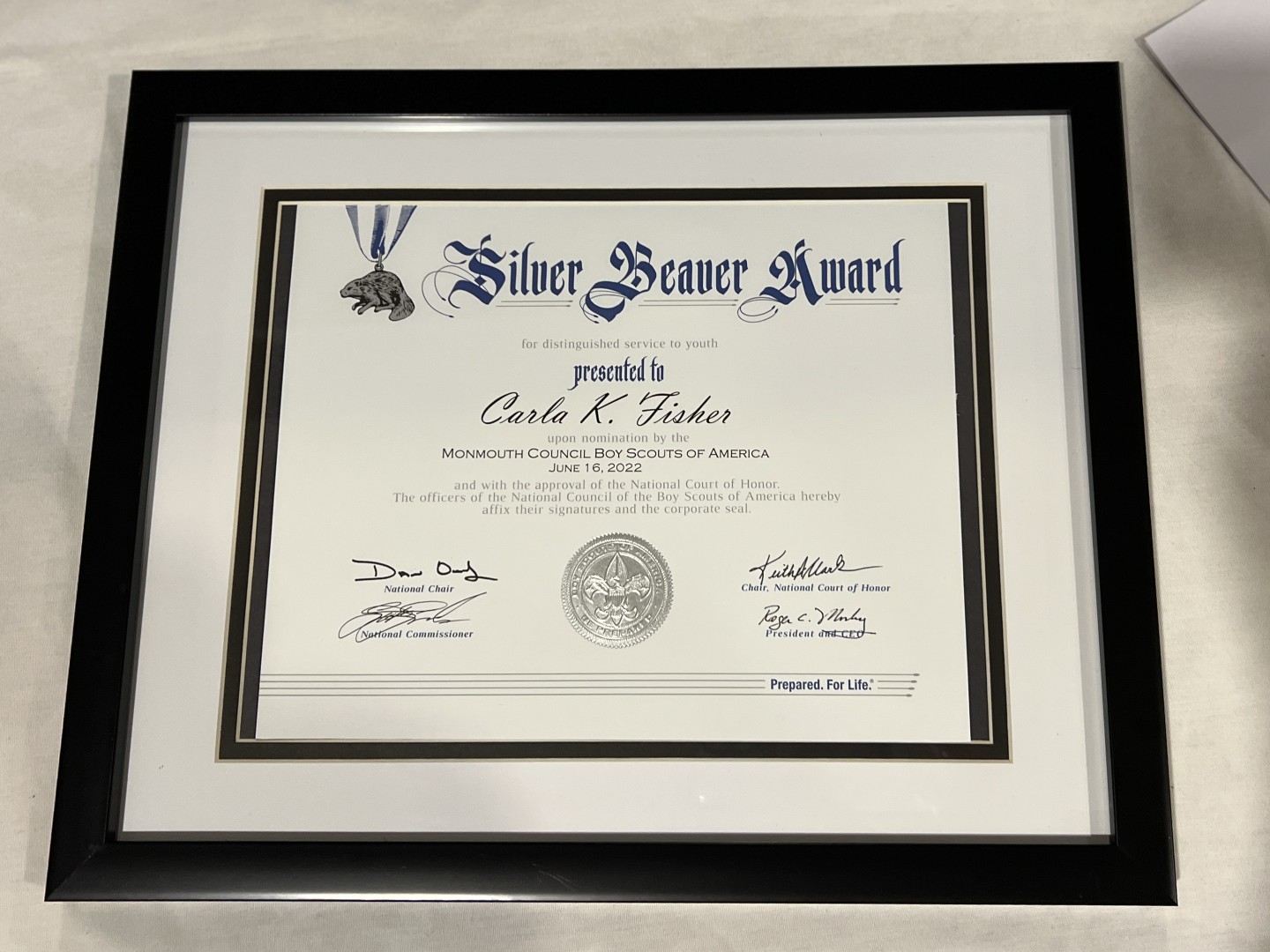 Framed Silver Beaver Award certificate presented to Carla K. Fisher for distinguished service to youth.