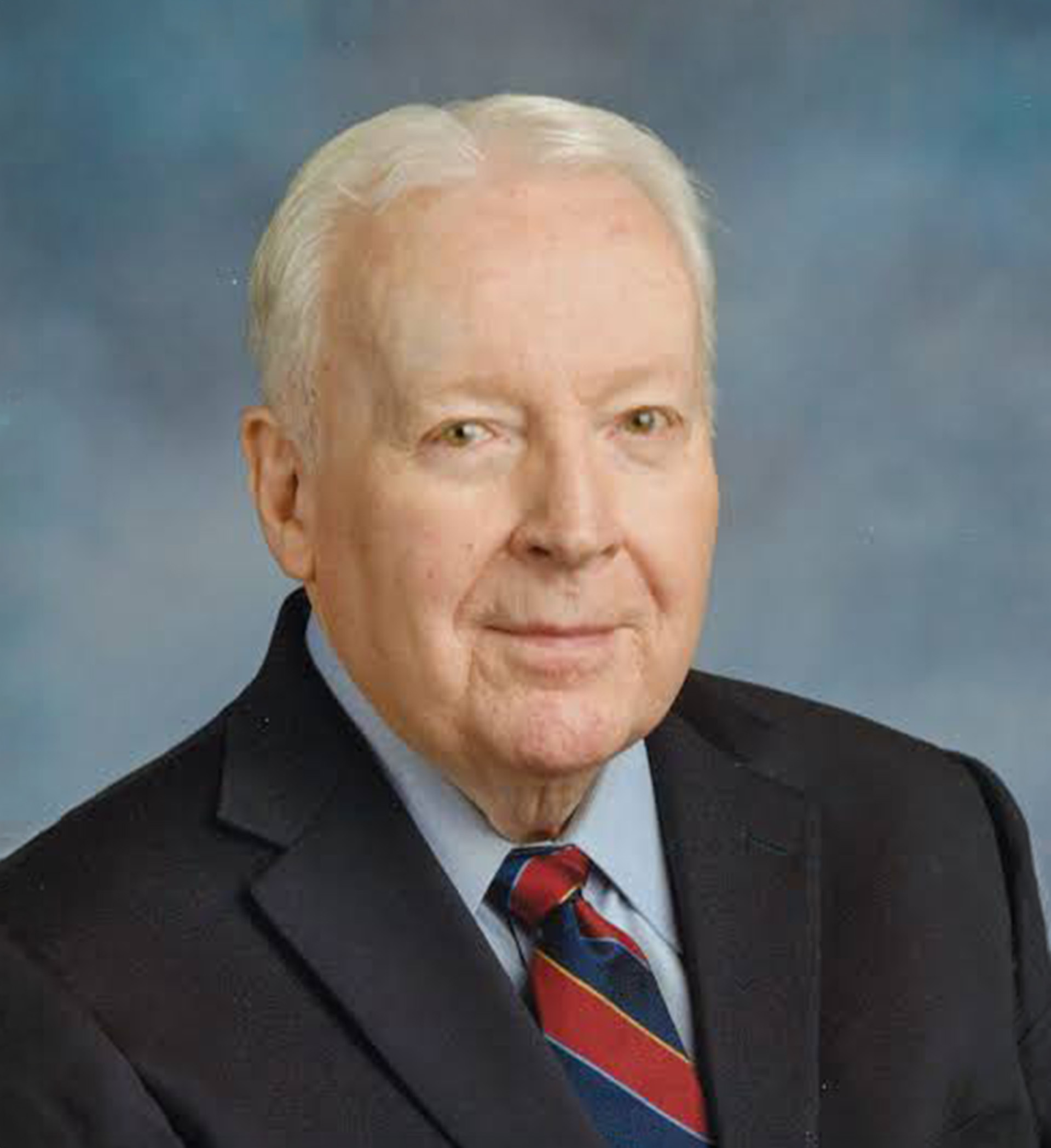 Robert P. Brady wearing a dark suit and striped tie in a professional headshot.