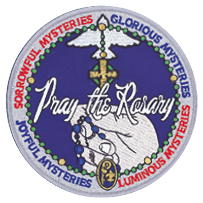 Circular “Pray the Rosary” badge featuring hands holding rosary beads, surrounded by the four mysteries of the Rosary.